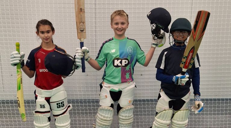 Young cricketers warming up indoors during a Centurion Academy training session at winter nets.